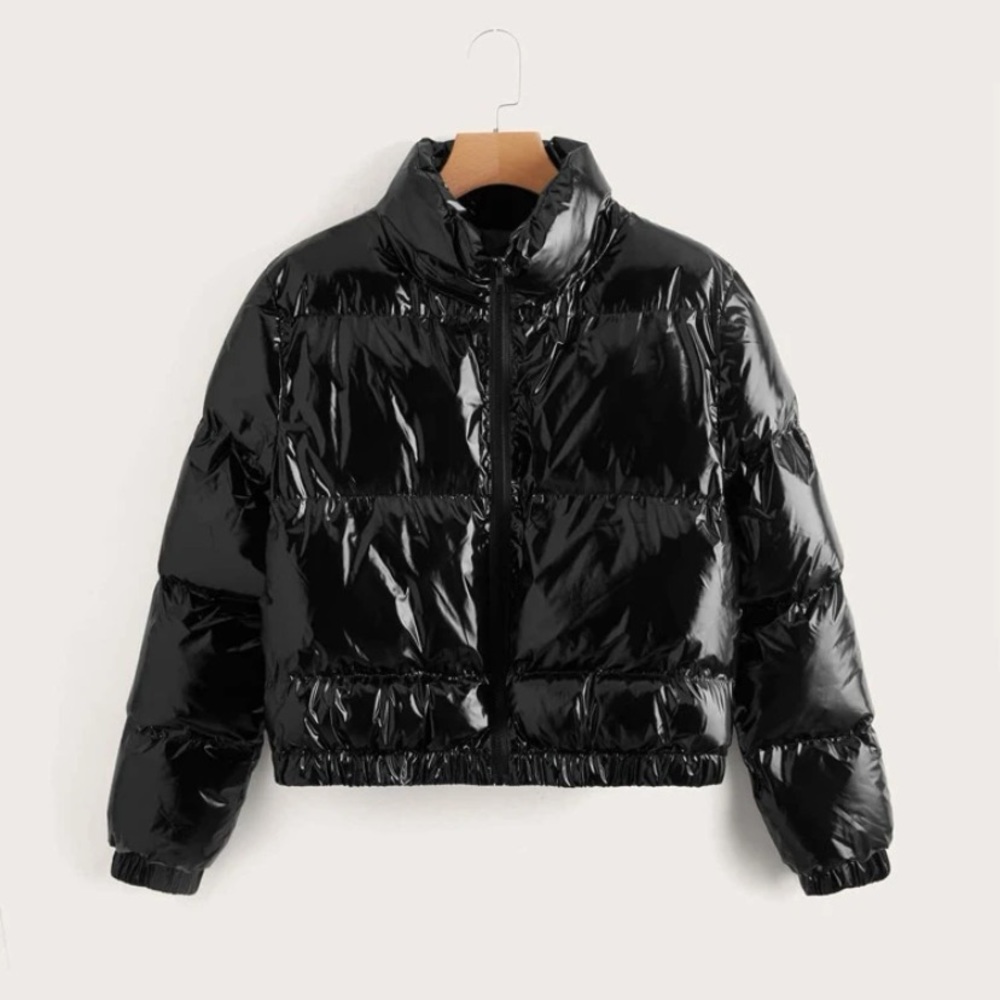 All black shinny jacket, with a front zipper, a collar, and is puffy.